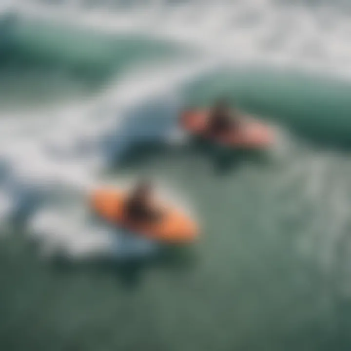 An aerial view of individuals sledding on boogie boards in powerful waves.