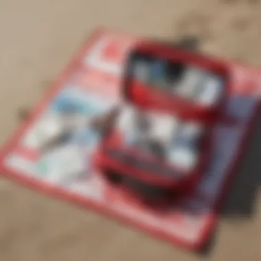 Essential Surf First Aid Kit Comprehensive surf first aid kit displayed on a beach towel.