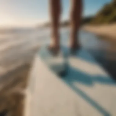 Close-up of a surfer's feet on a surfboard on a picturesque beach