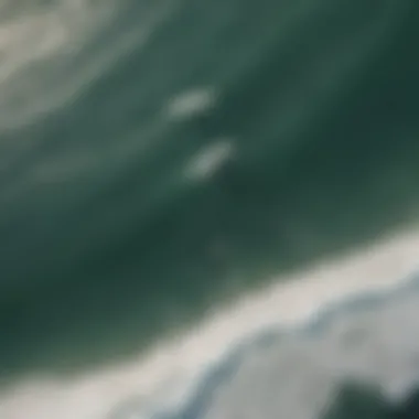 Surfers in Action from Above Aerial view of surfers riding the waves at a popular beach