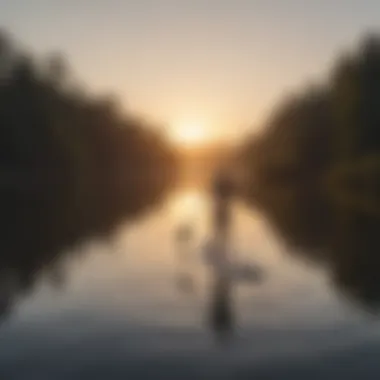 A serene moment of paddle boarding at sunrise on a tranquil lake