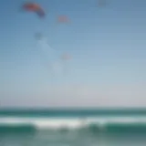 A vibrant kitesurfing scene on a Mexican beach, showcasing colorful kites soaring against the blue sky.