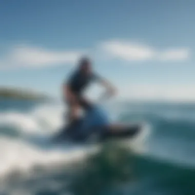 A kneeboarder gliding over the water with a backdrop of clear blue skies