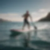 A dynamic paddleboarder gliding over waves showcasing speed skimming technique.