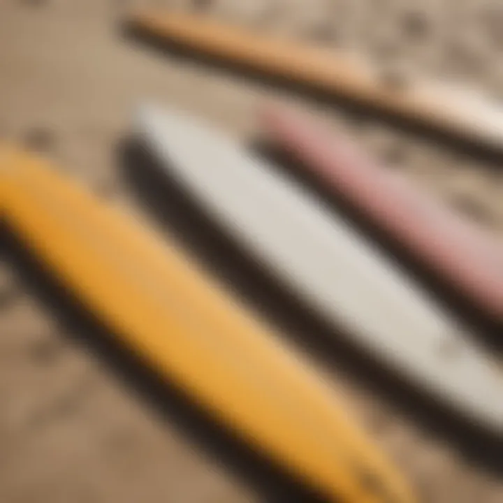 A close-up of different types of surfboards arranged on the sand