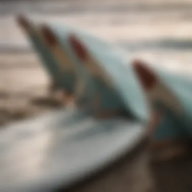 Close-up of a surfboard showing various fins setup