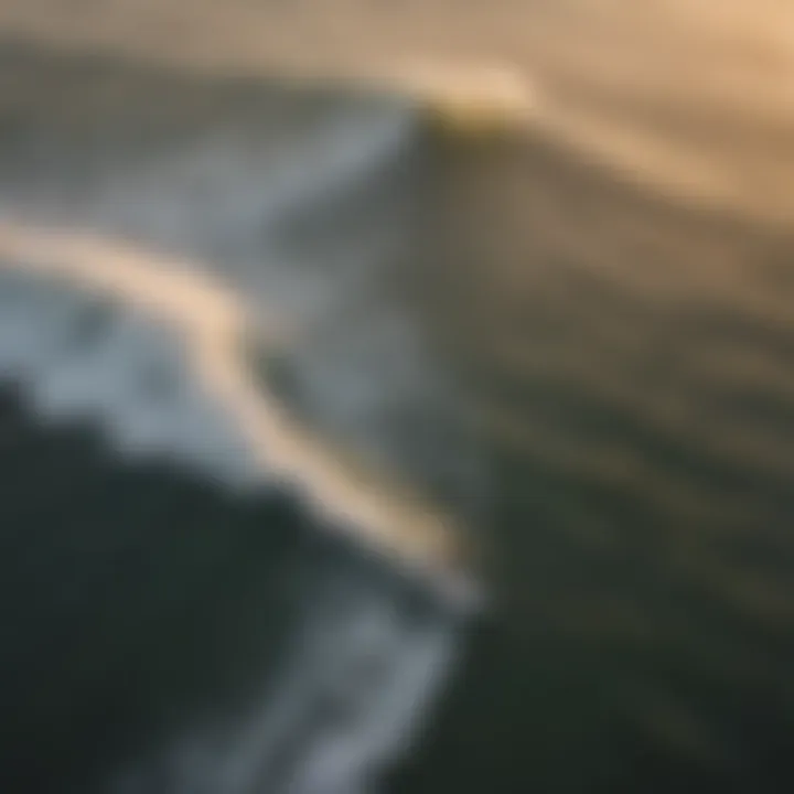 An aerial view of surfers riding waves during sunset