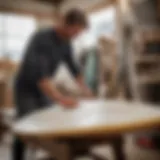 A skilled artisan shaping a surfboard with precision tools.