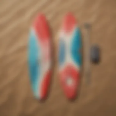 Surfboard and boardshorts laid out on a sandy beach, highlighting vibrant designs