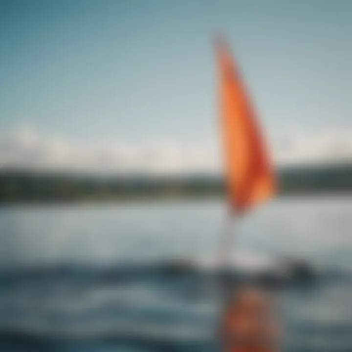 Vibrant windsock fluttering in the breeze over a serene water body