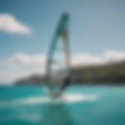 A breathtaking view of a windsurfer gliding across turquoise waters.